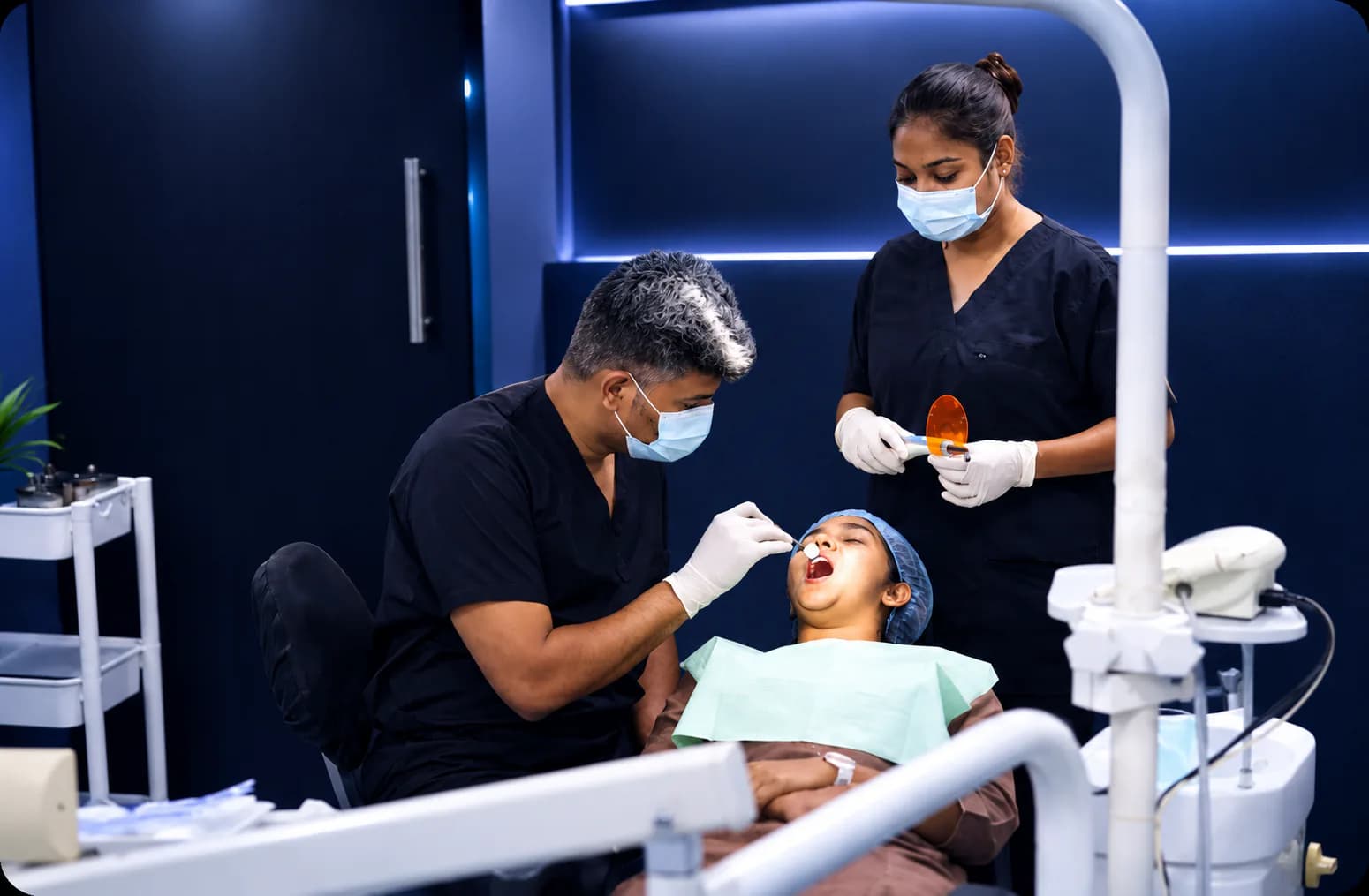 Dentists treating a patient at The Swish Dentistry